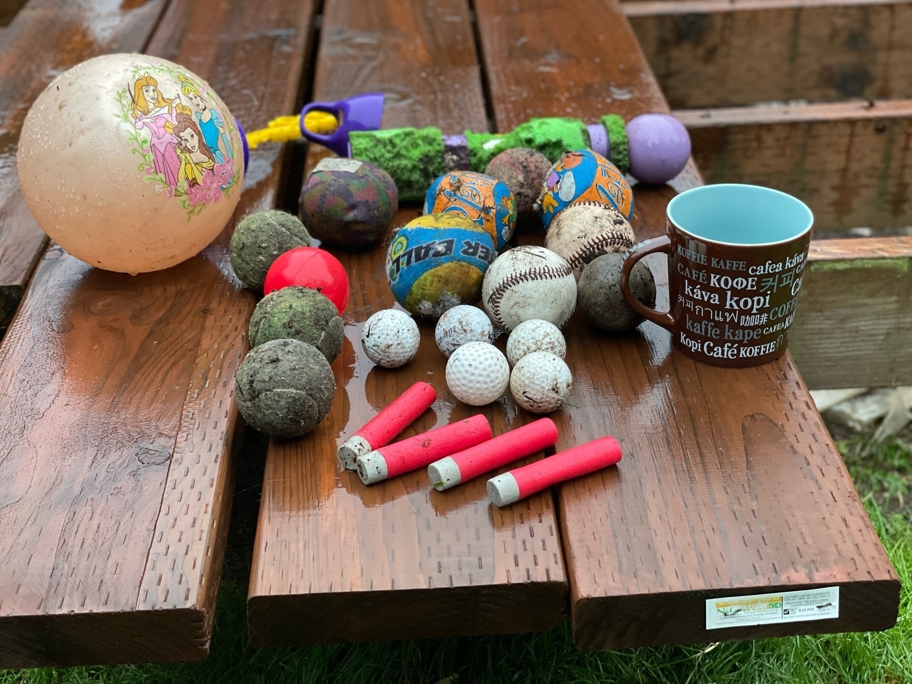 Various balls, bubble wands, Nerf darts, and a coffee mug