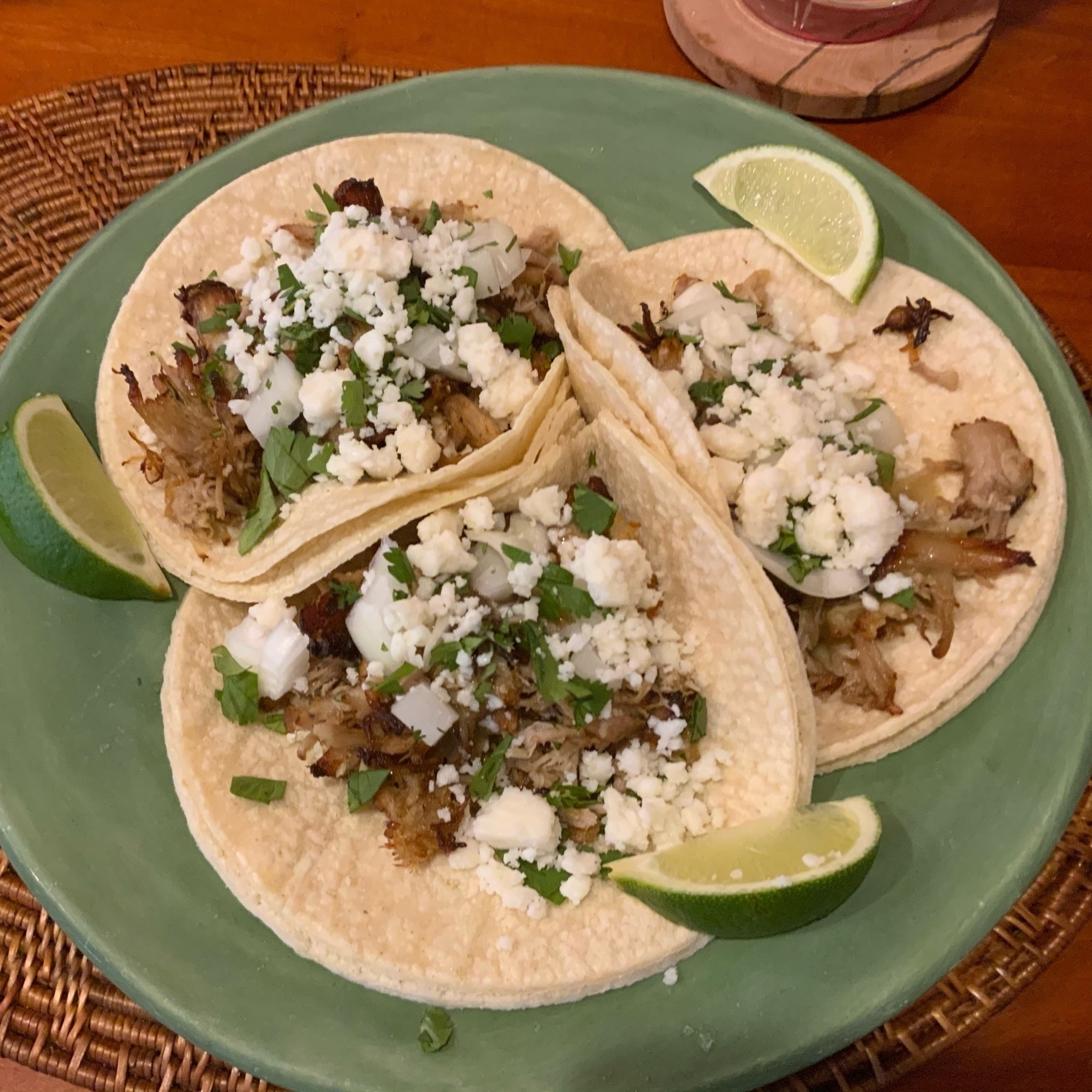 Three pork carnita tacos on a plate