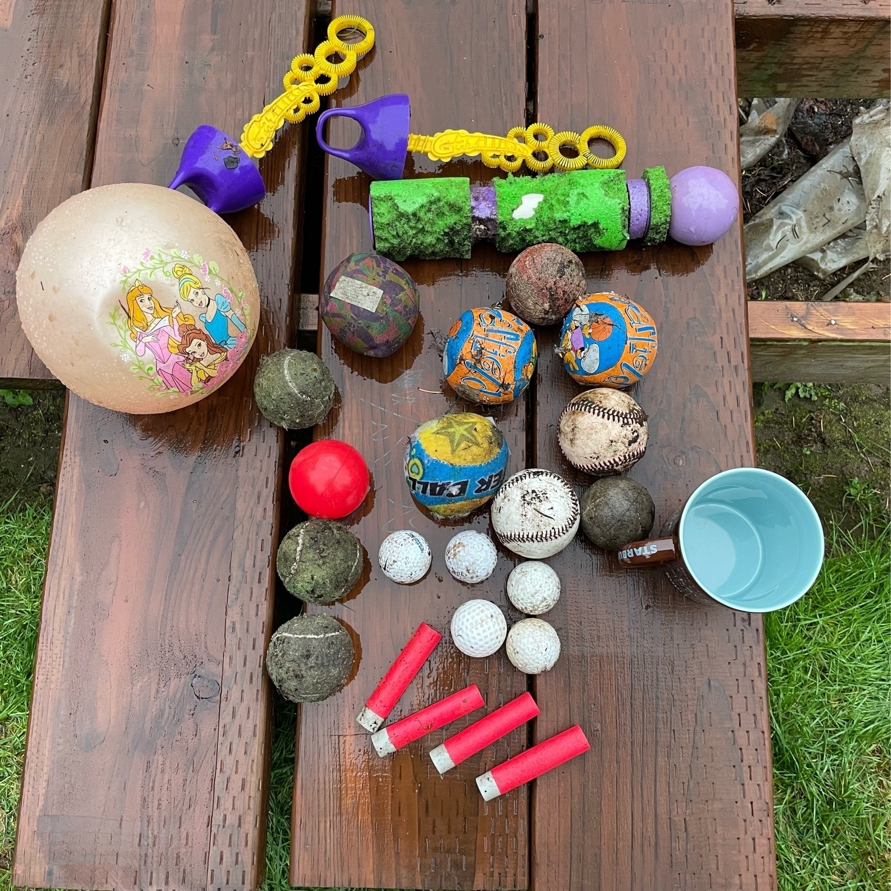 Overhead view of various balls, bubble wands, Nerf darts, and a coffee mug